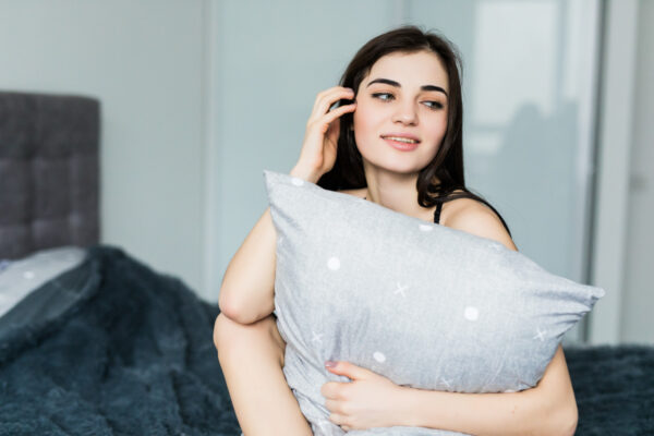 A girl holding Box Pillow Case of Fresh Linens